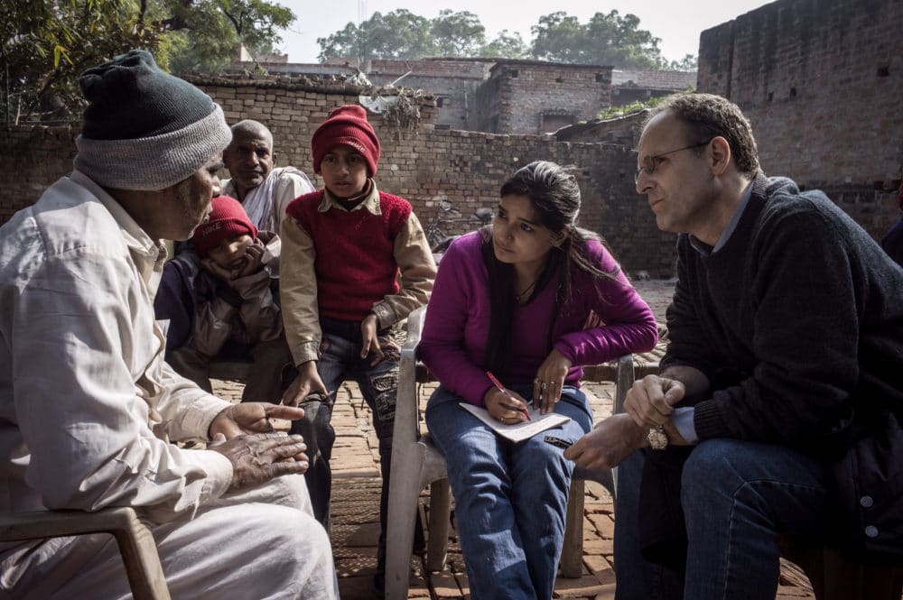 a man being interviewed by a man and women