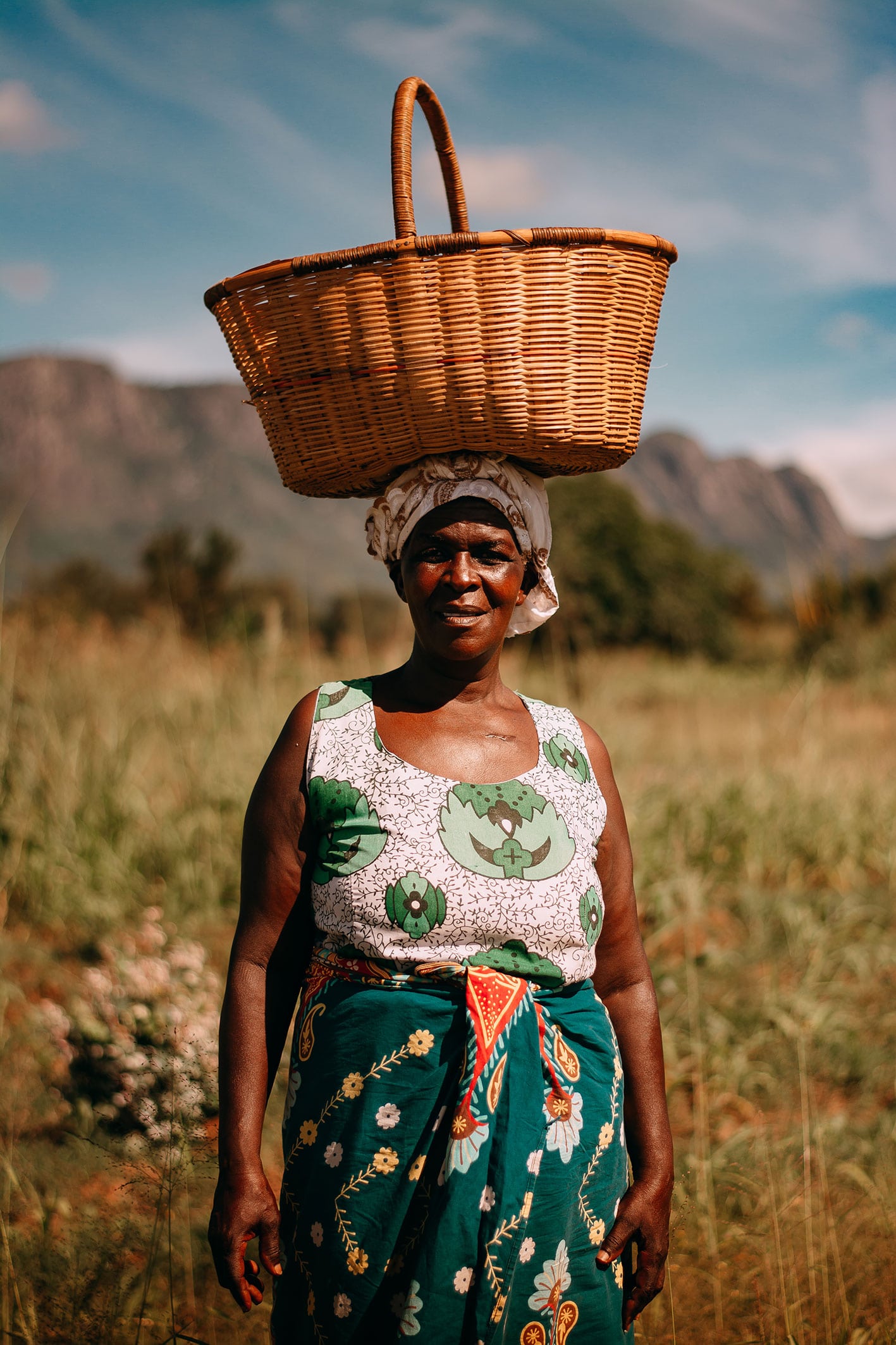 woman standing with a basket on her head